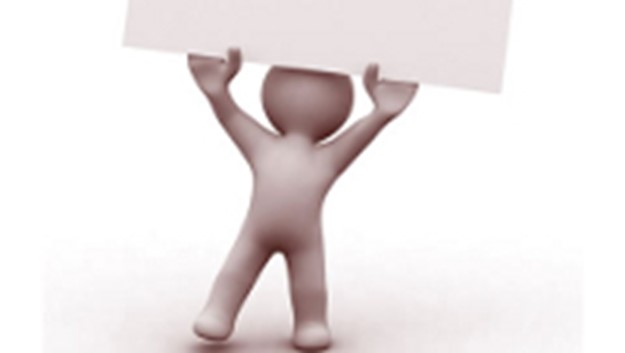 Image of figure holding up paper
